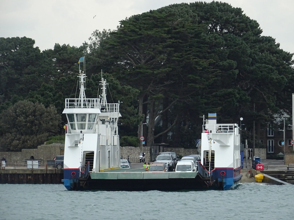 Ferry boat approaching a dock on calm water