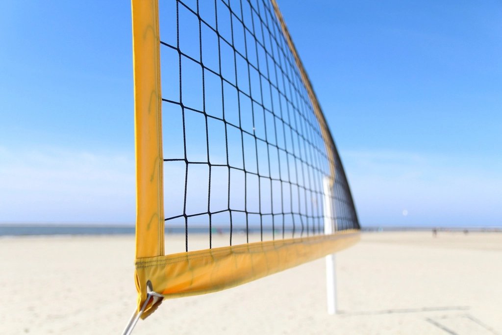 Volleyball near a net on an indoor court